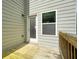Wooden deck with a door and window, attached to a home with light gray siding and a wooden railing at 1630 Eaglerock Dr, Suwanee, GA 30024