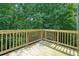 The wooden deck with railings overlooks a wooded area, creating a private outdoor space at 1630 Eaglerock Dr, Suwanee, GA 30024