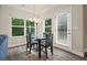 Cozy dining area filled with natural light and stylish lighting fixture with access to the patio at 1630 Eaglerock Dr, Suwanee, GA 30024