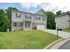 Classic two-story home with a well-manicured lawn, brick accents, and neutral-colored siding at 1630 Eaglerock Dr, Suwanee, GA 30024