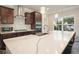 Modern kitchen featuring a large island with marble countertop and stainless steel appliances at 1630 Eaglerock Dr, Suwanee, GA 30024