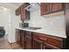 Gourmet kitchen featuring stainless steel appliances, white backsplash, and custom cabinets at 1630 Eaglerock Dr, Suwanee, GA 30024