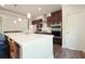 Modern kitchen features a large island with marble countertop and stainless steel appliances at 1630 Eaglerock Dr, Suwanee, GA 30024