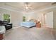 Spacious main bedroom with a tray ceiling, ceiling fan, carpet floors, and large windows at 1630 Eaglerock Dr, Suwanee, GA 30024