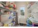 Walk-in pantry boasts ample shelving for organized storage and a window for natural light at 1630 Eaglerock Dr, Suwanee, GA 30024