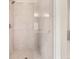Modern shower showcasing tiled walls, a glass door, and a sleek showerhead at 1630 Eaglerock Dr, Suwanee, GA 30024