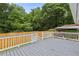 Open-air gray back deck with stairs overlooking the yard and bordered by a wood and white fence at 2049 Phillips Dr, Atlanta, GA 30315