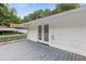 Back deck with white railing and siding with double doors that enter into the house at 2049 Phillips Dr, Atlanta, GA 30315