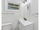 Bright bathroom featuring white fixtures, new vanity, light fixture, and updated accents at 2049 Phillips Dr, Atlanta, GA 30315