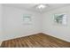 Spacious bedroom with hardwood floors and two windows for natural light at 2049 Phillips Dr, Atlanta, GA 30315