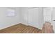Bright bedroom with closet, hardwood flooring and view to bathroom at 2049 Phillips Dr, Atlanta, GA 30315
