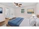 Staged bedroom featuring wood-look floors, ceiling fan, with a view into the attached bathroom at 2049 Phillips Dr, Atlanta, GA 30315