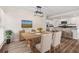 Open dining area featuring a wood table set for dinner and view of the kitchen at 2049 Phillips Dr, Atlanta, GA 30315