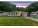 Charming single-story home with a well-maintained lawn and inviting curb appeal at twilight at 2049 Phillips Dr, Atlanta, GA 30315
