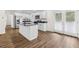 Modern kitchen with stainless steel appliances, kitchen island, and access to the backyard at 2049 Phillips Dr, Atlanta, GA 30315