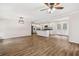 Open-concept living room with wood floors and adjacent white kitchen with stainless steel appliances at 2049 Phillips Dr, Atlanta, GA 30315