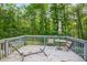 Outdoor deck with wooden planks, surrounded by a lush green forest setting at 3328 Hidden Bluff Trl, Snellville, GA 30039