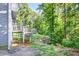 Backyard view showing multi-tiered decks surrounded by lush trees and greenery at 3328 Hidden Bluff Trl, Snellville, GA 30039