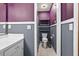 Compact bathroom showing a toilet and shelving unit with painted two-tone walls at 3328 Hidden Bluff Trl, Snellville, GA 30039