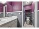 Compact bathroom showing a toilet and shelving unit with painted two-tone walls at 3328 Hidden Bluff Trl, Snellville, GA 30039