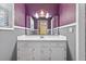 Well-lit bathroom featuring a white vanity with storage and a large mirror at 3328 Hidden Bluff Trl, Snellville, GA 30039