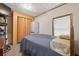 Cozy bedroom featuring a full size bed, wood closet, and natural light from a window at 3328 Hidden Bluff Trl, Snellville, GA 30039