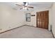 Bright bedroom featuring a window, closet, and neutral carpeting at 3328 Hidden Bluff Trl, Snellville, GA 30039