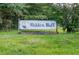 Entrance sign to Hidden Bluff neighborhood featuring a simple design with blue lettering at 3328 Hidden Bluff Trl, Snellville, GA 30039