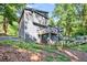 Exterior side view of a gray two-story home with multi-tiered decks in a wooded setting at 3328 Hidden Bluff Trl, Snellville, GA 30039
