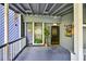 Cozy front porch with classic railings, decor, and a covered entryway at 3328 Hidden Bluff Trl, Snellville, GA 30039