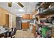 Functional kitchen with stainless steel appliances, wood cabinets, and organized metal shelving unit at 3328 Hidden Bluff Trl, Snellville, GA 30039