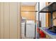 Small laundry area featuring a washer, dryer, utility sink and some storage at 3328 Hidden Bluff Trl, Snellville, GA 30039