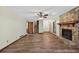 Spacious living room with hardwood floors, stone fireplace, and ceiling fan at 3328 Hidden Bluff Trl, Snellville, GA 30039