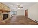 Open living room with hardwood floors, stone fireplace, and bay window at 3328 Hidden Bluff Trl, Snellville, GA 30039