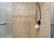 An elegant tiled shower features upgraded showerhead and stylish stone flooring at 3328 Hidden Bluff Trl, Snellville, GA 30039