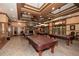 Recreation room with several pool tables, a stone fireplace, and comfortable seating for socializing at 505 Appalachian Woods Dr, Canton, GA 30114