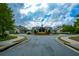The community clubhouse features manicured landscaping, circular driveway, and inviting architecture at 505 Appalachian Woods Dr, Canton, GA 30114