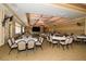 Large event space furnished with round tables, chairs, chandeliers and large windows at 505 Appalachian Woods Dr, Canton, GA 30114