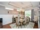 Formal dining room with coffered ceiling, elegant chandelier, and neutral decor at 505 Appalachian Woods Dr, Canton, GA 30114