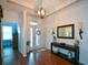 Stately entryway with hardwood floors, tray ceiling, console table and decorative mirror at 505 Appalachian Woods Dr, Canton, GA 30114
