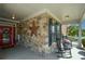 Inviting front porch with stone accents, rocking chairs, and a bright red front door at 505 Appalachian Woods Dr, Canton, GA 30114