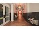 Hallway featuring wood-look flooring, paneled walls, and stylish lighting at 505 Appalachian Woods Dr, Canton, GA 30114