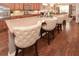 Kitchen island with granite countertops and stylish seating, complemented by hardwood floors at 505 Appalachian Woods Dr, Canton, GA 30114