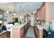 Open kitchen with granite island and bar seating adjacent to living area with fireplace at 505 Appalachian Woods Dr, Canton, GA 30114