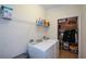 Functional laundry room with modern washer and dryer units and storage shelves at 505 Appalachian Woods Dr, Canton, GA 30114