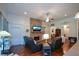 Cozy living room with a stone fireplace, hardwood floors, neutral decor, and comfortable seating at 505 Appalachian Woods Dr, Canton, GA 30114