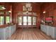 An elegant lobby area with wood paneling, stylish gray console tables and modern lighting features at 505 Appalachian Woods Dr, Canton, GA 30114