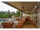 Beautiful covered patio with wooden floors and comfortable seating area overlooking the pool at 505 Appalachian Woods Dr, Canton, GA 30114