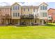 Spacious backyard featuring lawn and townhouse exteriors with decks and covered patios at 6426 Queens Court Trce # 7, Mableton, GA 30126