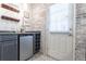 Modern bar area with wine racks, mini-fridge, and decorative brick accent wall at 6426 Queens Court Trce # 7, Mableton, GA 30126